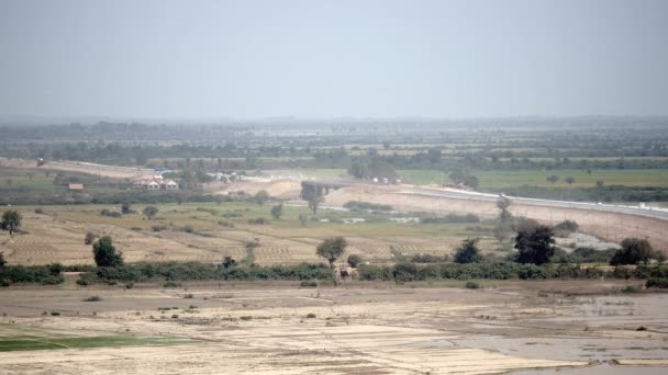 Distance view on dusty paved road with traffic.  (time lapse ) — Stock Video