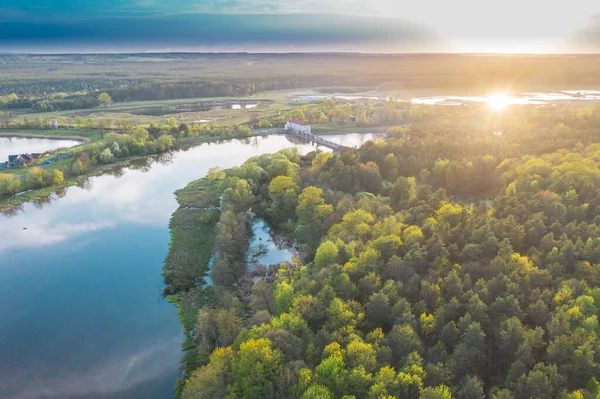 The river Bobr, near the city of Zagan, in Poland, flowing through the forest, seen from above. Photo from the drone.