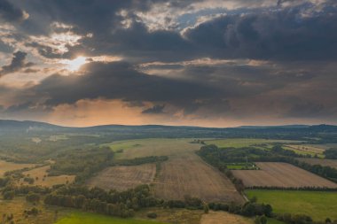 Ovadaki tarlalar ve çayırlar. Ufuktaki Karkonosze Dağları 'nın sisli zirveleri. İnsansız hava aracından görüntüle.