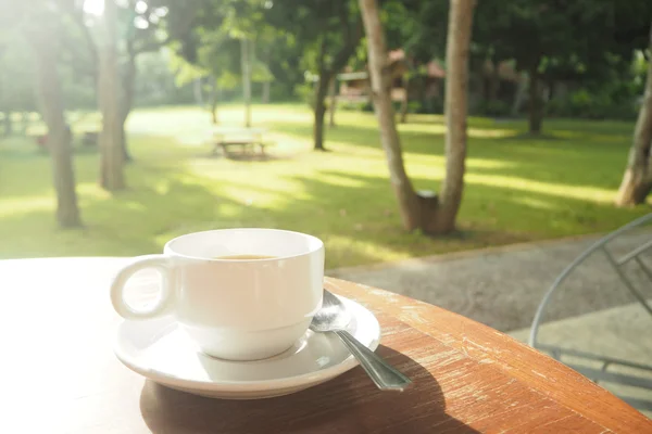 Чашка белого кофе на деревянном столе — стоковое фото