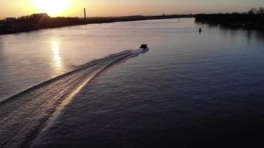 Hollanda, Güney Hollanda 'da Altın Saat sırasında Sessiz Oude Maas Nehri' nden geçen Sürat teknesinin Manzarası. - Havadan İzleme Görüntüsü