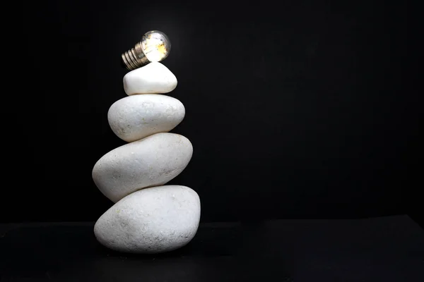 White Stones Stacked Lit Light Bulb Isolated Black Background Macro — Stock Photo, Image