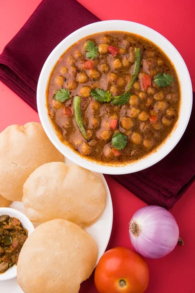 stock image spicy chick peas also known as Chola Masala or Chana Masala or Chole served with fried puri, pickle and green salad