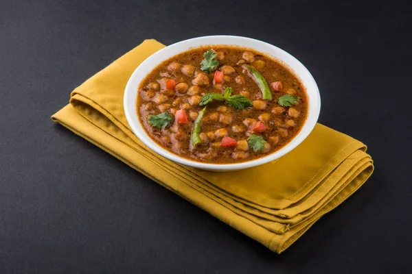 Indian dish spicy Chick Peas also known as Chola Masala or Chana Masala or Chole served in a white bowl, isolated — Stock Photo, Image