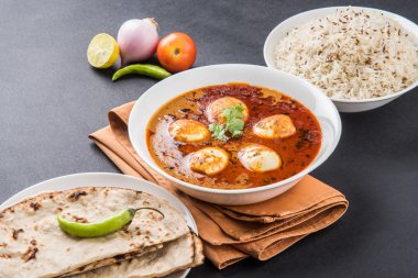 yumurta roti/Çapati ve jeera pirinç köri, lezzetli ve baharatlı anda köri Hint yumurta masala köri roti ve pilav ile servis roti, salata ve jeera pirinç seramik kase
