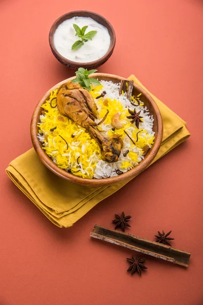 Chicken Biryani with yogurt dip on beautiful moody background, selective focus — Stock Photo, Image