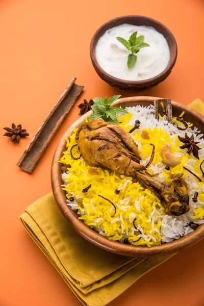 Chicken Biryani with yogurt dip on beautiful moody background, selective focus — Stock Photo, Image