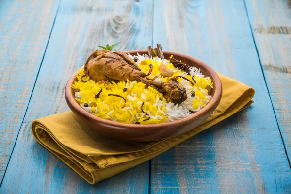 Chicken Biryani with yogurt dip on beautiful moody background, selective focus — Stock Photo, Image