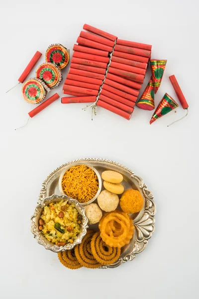 Diwali food and diwali firecrackers together, isolated on white background — Stock Photo, Image