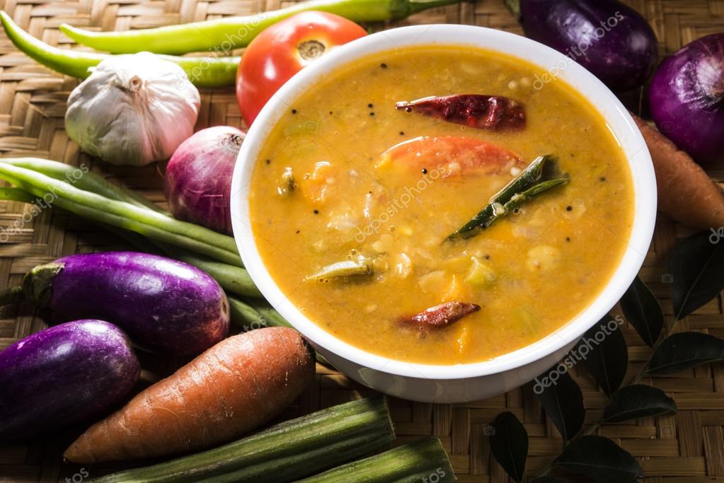 South indian vegetable sambar, with vegetables isolated on wooden ken