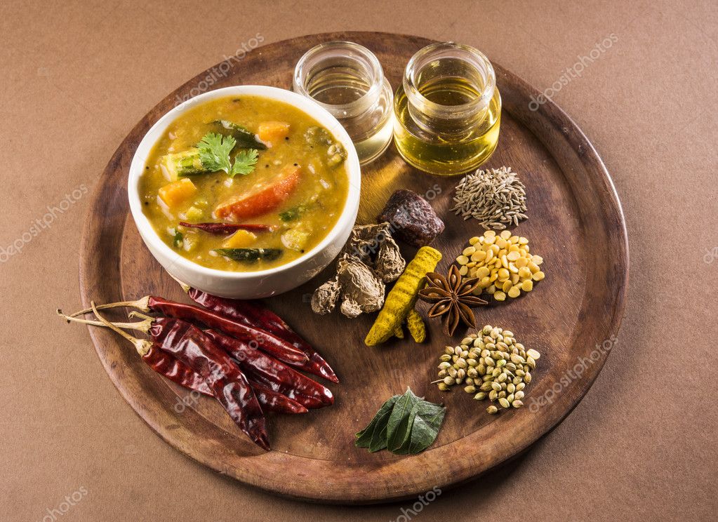 South indian vegetable sambar, with vegetables isolated on wooden ken