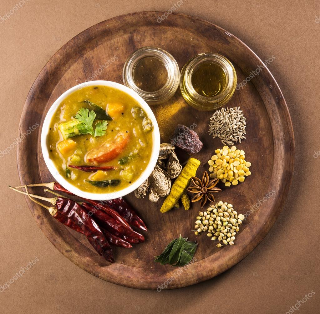 South indian vegetable sambar, with vegetables isolated on wooden ken