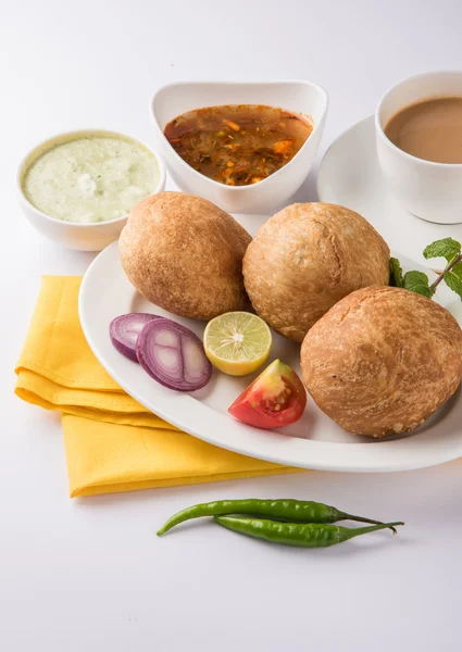 Kachori or Kachauri or Kachodi or Katchuri is a spicy snack popular in various parts India, pakistan. with green salad, pudina chutney and tea in white crockery — Stock Photo, Image