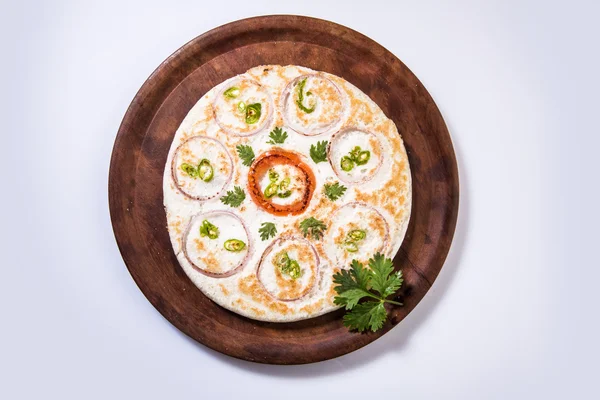 south indian food, two uttapam with coconut chutney in white ceramic plate with coriander leaf, closeup and front view, isolated on white background