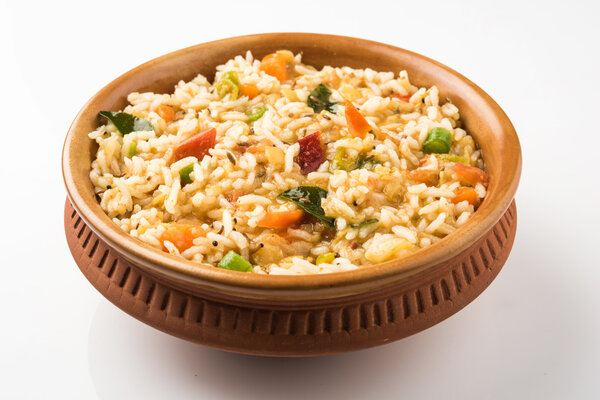 sambar rice / rice sambar / sambar mixed with rice, tasty south indian dish served in a terracotta bowl, isolated