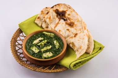 palak paneer with indian bread or roti or chapati or naan clipart