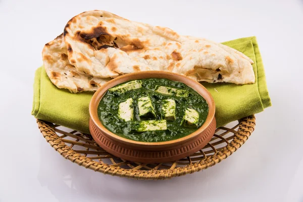 palak paneer with indian bread or roti or chapati or naan