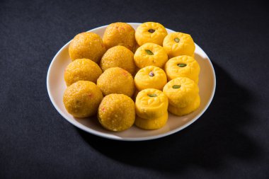 indian sweets bundi laddu or motichur laddu and kesar pedha or pera clipart