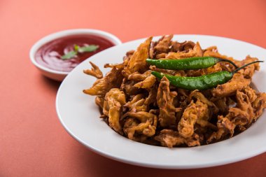 Çıtır soğan bhaji veya kanda bhaji veya kızarmış soğan pakore veya pakode, lezzetli sokak gıda, favori Hint aperatif muson içinde sıcak çay ile servis