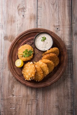 tasty sabudana vada or sabudana vade made up of Sago served with peanut chutney, a famous fasting recipe or snack from maharashtra, India clipart