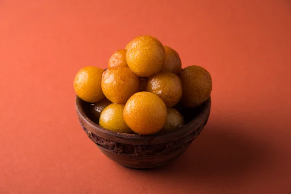 굴라브 자문(gulaab jamun)은 우유 고형제 기반의 달콤한 미타이로 나무 그릇에 담겨 서빙됩니다. — 스톡 사진