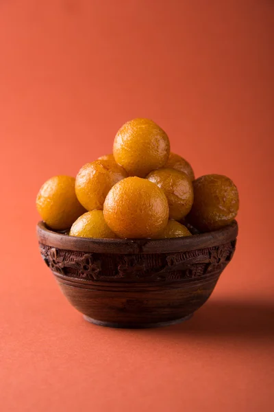 Gulab jamun, o gulaab jamun, es un mithai dulce a base de sólidos lácteos servido en un tazón de madera. — Foto de Stock