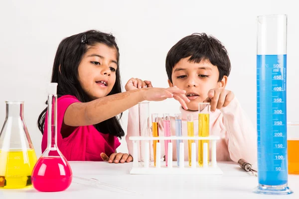 4 year old indian boy and girl doing science experiment, science Education. asian kids and science experiments, chemistry experiment, indian kids and science experiments, indian kids and science lab