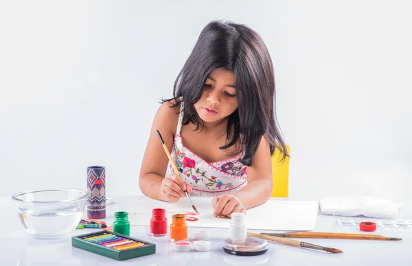 indian girl colouring or painting, asian girl with paint brush