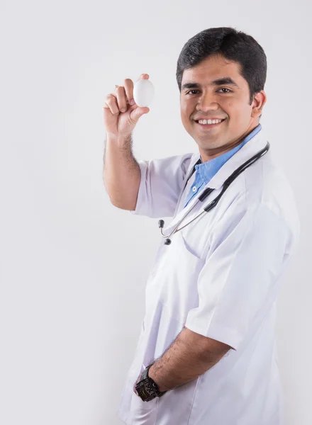 Médico Indiano Bonito Segurando Mostrando Ovo Isolado Sobre Fundo Branco — Fotografia de Stock