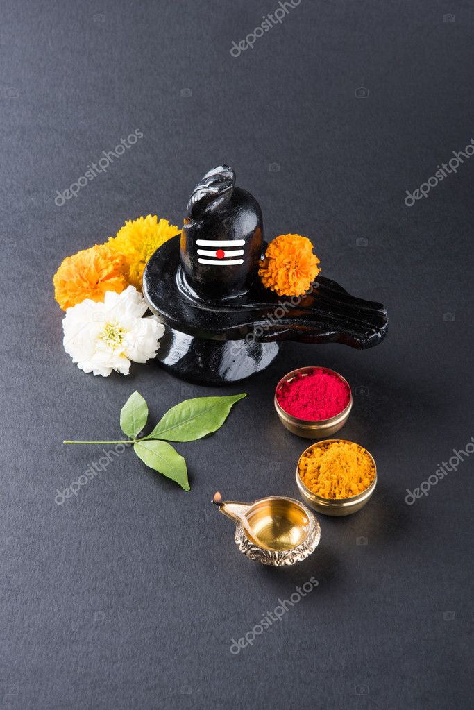Shiva Linga made up of black stone decorated with flowers & bael leaf known  as Aegle