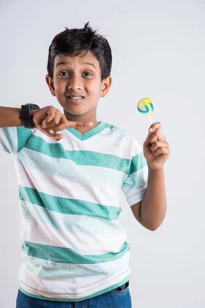 Indian small boy with lolipop or loly pop, asian boy and lolipop or lolypop, playful indian boy posing with lolipop or candy — Stock Photo, Image