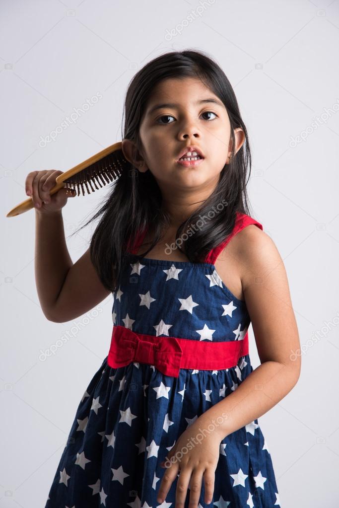 Indian Small Girl And Hair Brush Stock Photo C Stockimagefactory