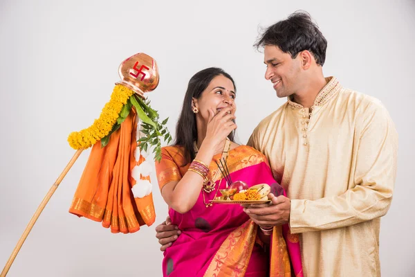 smart indian couple in traditional wear performing gudhi padwa puja, asian couple & puja thali, indian young couple with puja or pooja thali, hindu new year gudhi / gudi padwa, isolated