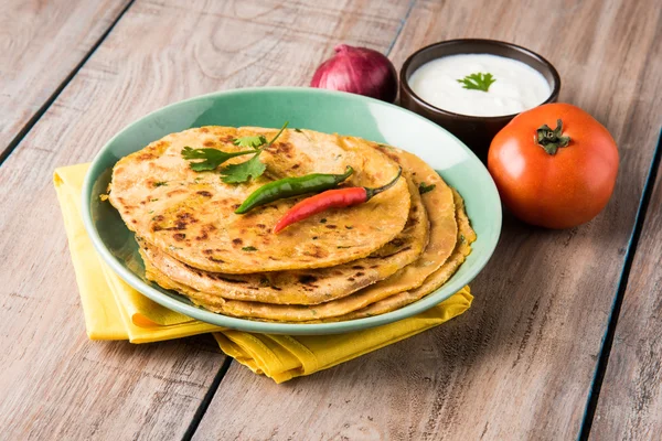Традиционный индийский хлеб - Aloo paratha или aalu parotha, картофельный фаршированный хлеб. подается с томатным кетчупом или соусом с творогом — стоковое фото