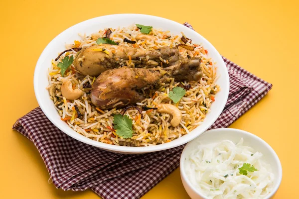 Chicken biryani with leg piece and raita — Stock Photo, Image