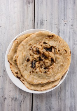 indian special bread also known as butter roti, chapati, naan, kulcha, paratha, tanduri roti clipart