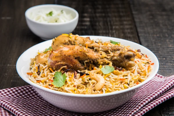 Chicken biryani with leg piece and raita — Stock Photo, Image