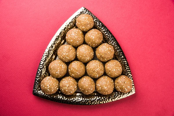 The indian sesame sweet or tilgul laddu or til gul laddu, made up of jaggery and sesame seeds, hand made, round, indian sweet prepared in Makar Sankranti festival