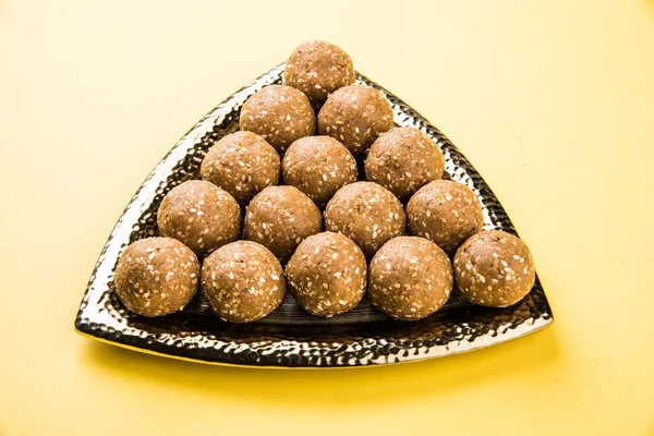 The indian sesame sweet or tilgul laddu or til gul laddu, made up of jaggery and sesame seeds, hand made, round, indian sweet prepared in Makar Sankranti festival