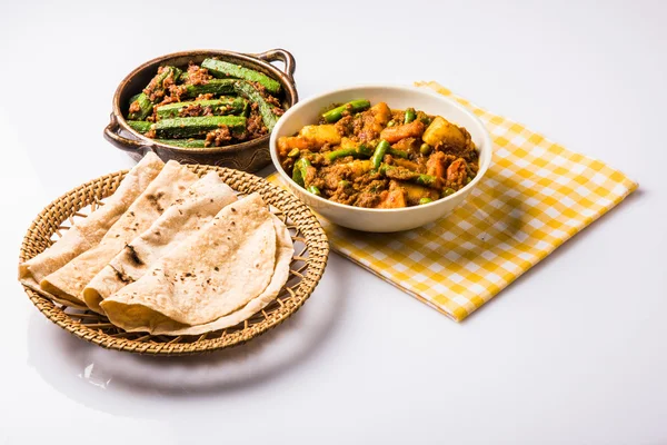 bhindi masala or bhendi masala or ladies finger fry with mixed veg in red curry with indian roti / chapati / fulka / paratha / indian bread, indian spicy food