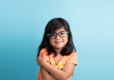 gözlüklü küçük hintli kız, mavi arka plan üzerinde closeup, asyalı kız, 4 yıl hint kız, gülümseyen, sevimli bakmak, studious, siyah saçlı, uzun siyah saçlı, ön görünüm, pasaport fotoğraf