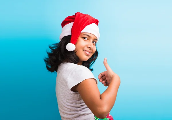 small cute indian girl with christmas hat, thinking, indian girl and christmas, christmas and india, indian kids and christmas, indian kids celebrating christmas, asian girl and christmas, thinking