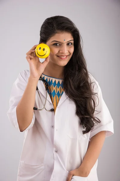 young indian woman doctor with smiley ball