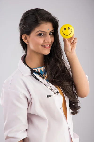 young indian woman doctor with smiley ball