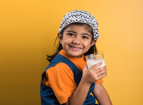 4 year old indian girl with a glass full of plain white milk, indian girl and plain milk, indian girl drinking milk, asian girl and milk glass, portrait, brown skin, indian baby girl