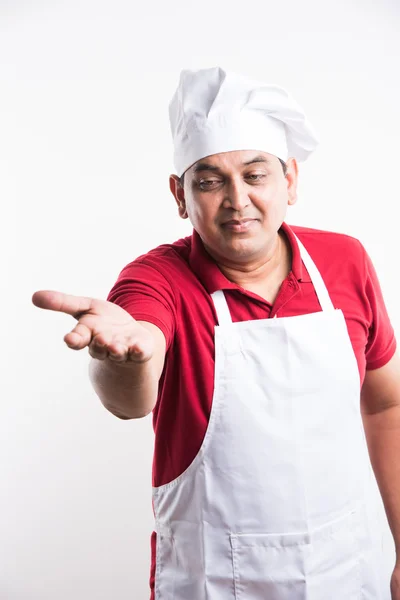 Portret van knappe Indiase mannelijke chef-kok te introduceren iets bereiken naar camera, Aziatische mannelijke chef-kok presenteren iets, geïsoleerd over witte achtergrond — Stockfoto