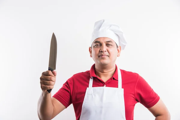 An image of a young indian male cook or indian male chef with knife, isolated over white background — Stock Photo, Image