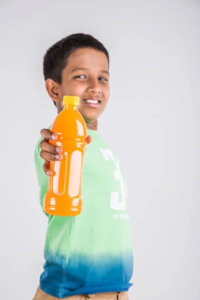 indian boy with cold drink bottle, asian boy holding cold drink bottle, small boy and cold drink, indian cute boy holding mango juice or orange juice bottle