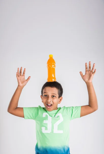 Indischer Junge mit Kaltgetränkflasche, asiatischer Junge mit Kaltgetränkflasche, kleiner Junge mit Kaltgetränk, süßer indischer Junge mit Mangosaft- oder Orangensaftflasche — Stockfoto