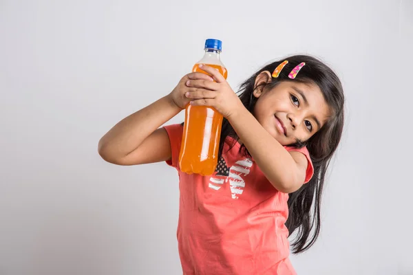indian girl with cold drink bottle, asian girl drinking cold drink in pet bottle, girl kid and cold drink, indian cute girl with mango or orange cold drink in plastic bottle, isolated